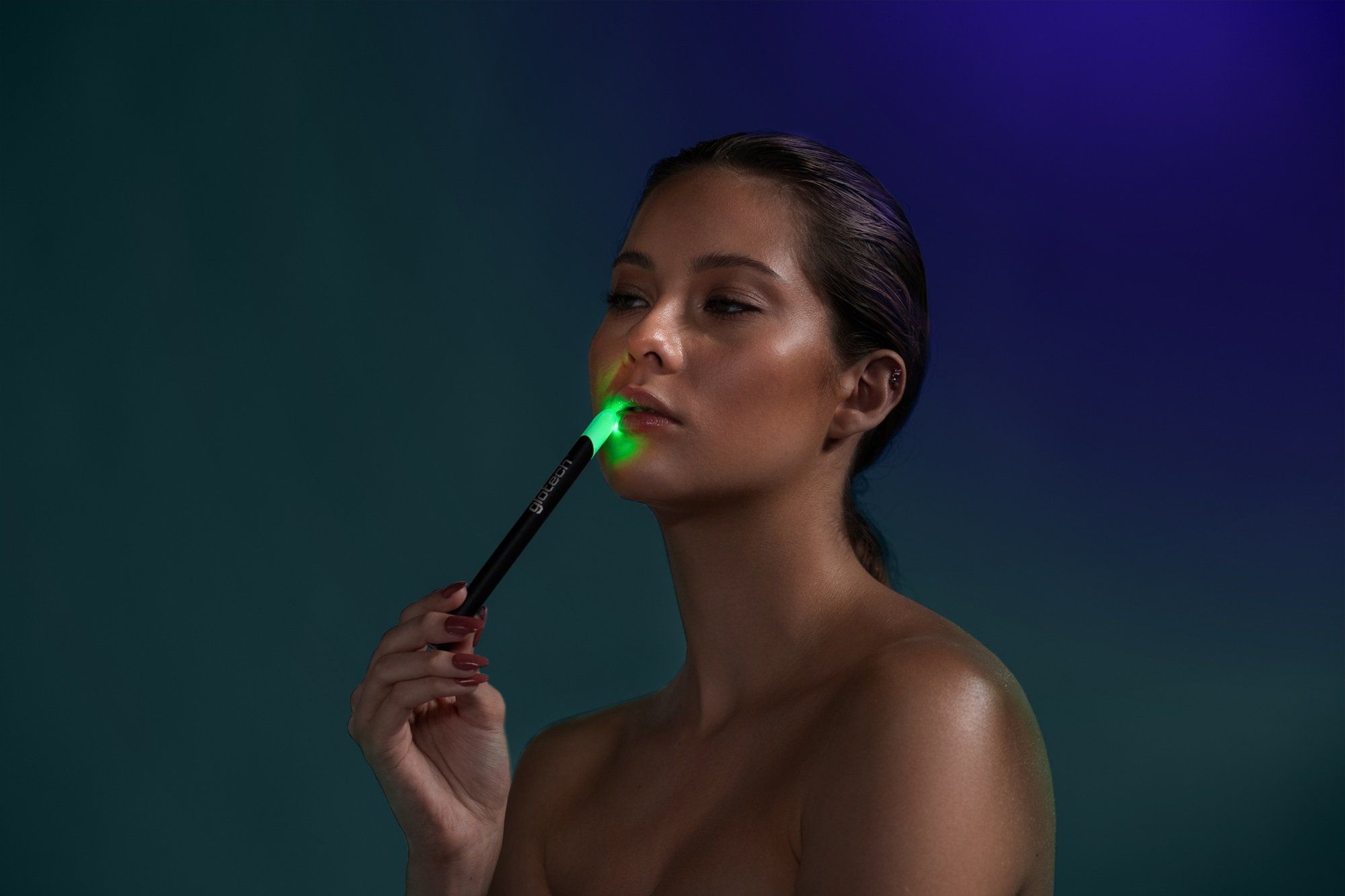 Model holding an LED skincare wand, from one of our beauty shoots