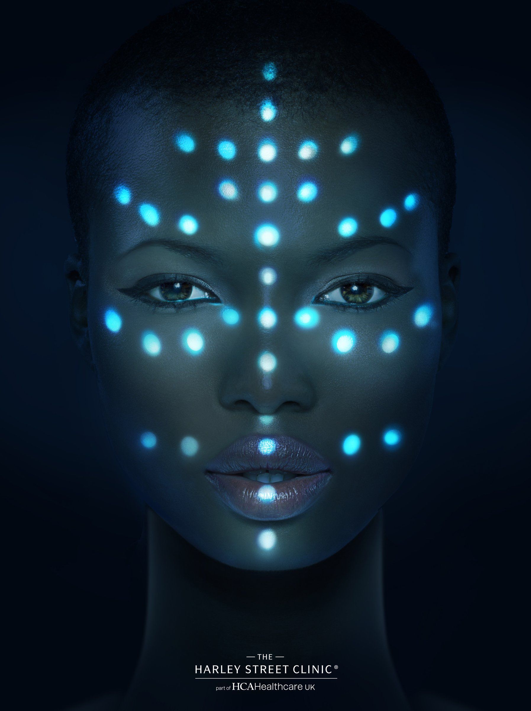 Model with LED treatment points mapped across her face