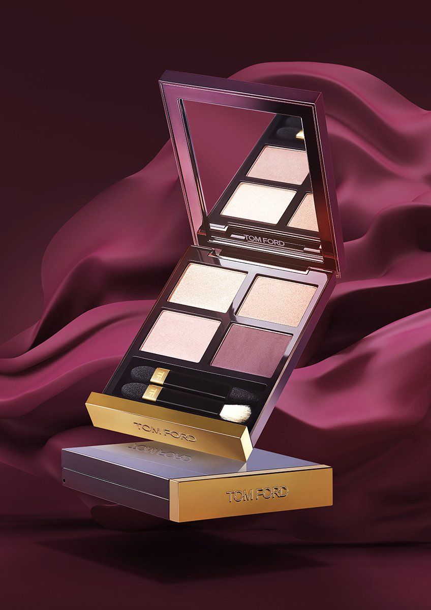 Tom Ford eyeshadow palette floating over plum silk